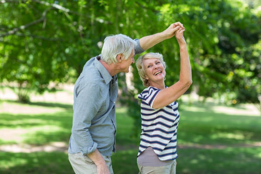 Senior couple dancing in park-min