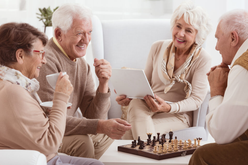 Happy friendships of retirement home playing chess