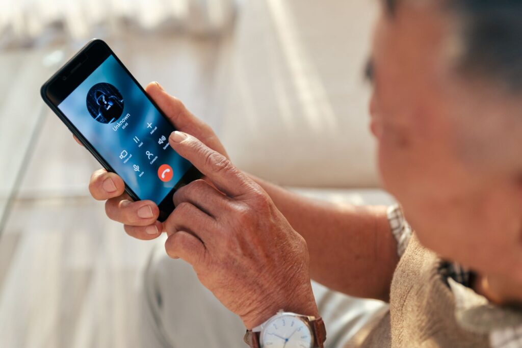 Senior answering a phone call from an unknown number