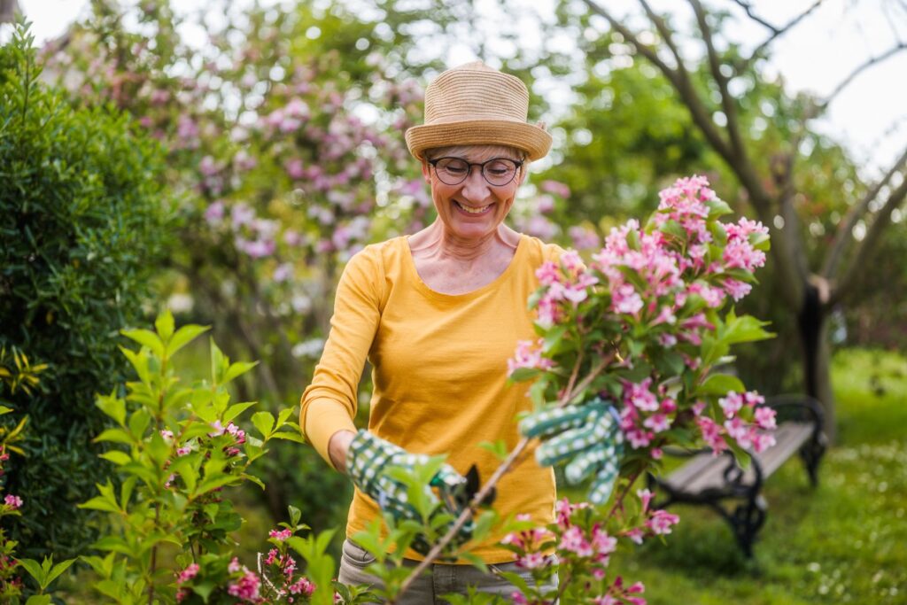 Older adult enjoying gardening as one of many fun ways for seniors to stay active in retirement communities