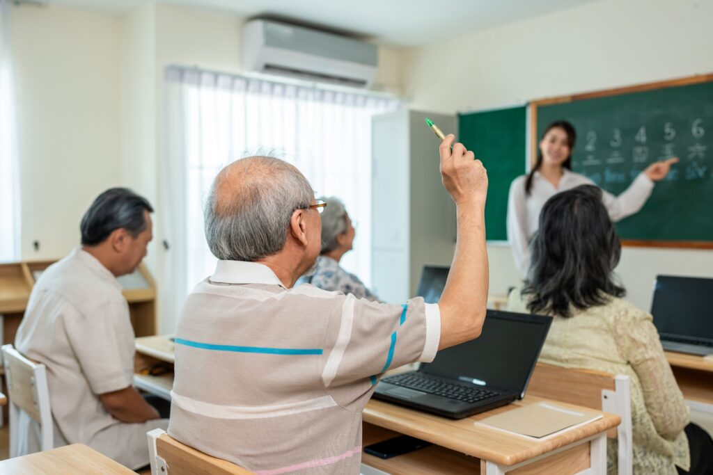 Senior adults participating in an engaging classroom session reflecting social retirement trends at Village Green Senior Living